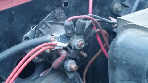 1985 Ford Bronco - This image shows the battery terminal connections and wiring within a vehicle's engine bay.