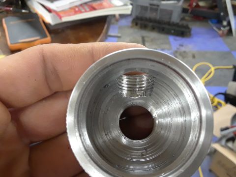 1994 Ford Bronco - Close-up of a machined metal part showing internal threading and a central hole.
