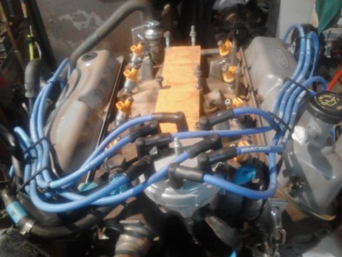1995 Ford Bronco - Close-up view of an engine assembly with various components visible.