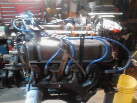 1995 Ford Bronco - Engine assembly with blue spark plug wires and orange fuel injectors visible.
