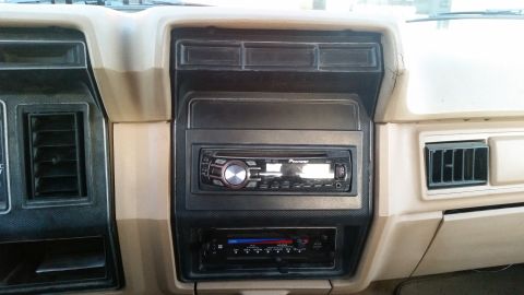 1985 Ford Bronco - Interior view of a car dashboard, showing a car stereo system and air vents.