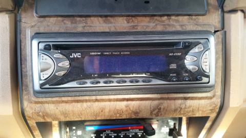 1985 Ford Bronco - A JVC KD-SS50 stereo is installed in the dashboard of a vehicle, with climate controls visible below.