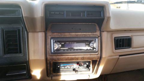 1985 Ford Bronco - Interior view of a vehicle's dashboard, showing the center console with aftermarket audio equipment.