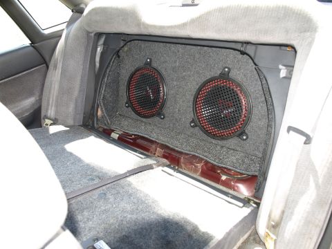 1994 Subaru Legacy - Aftermarket speakers installed in the rear of a car's interior.