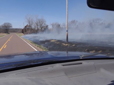 1994 Ford Bronco - Smoke rises from a controlled burn along the side of a rural road.