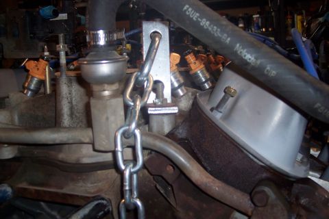 1995 Ford Bronco - Close-up view of engine parts, including fuel injectors and hoses, with visible part numbers.