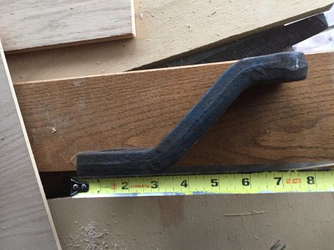 1967 Ford Custom Wagon - A metal bracket is shown with a tape measure for scale, indicating its size.
