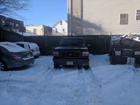 1995 Ford Bronco - Front view of a black 1995 Ford Bronco parked in a snowy lot.