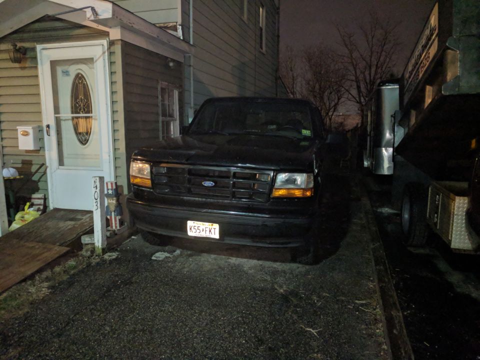 Black Ford Bronco parked in driveway at night