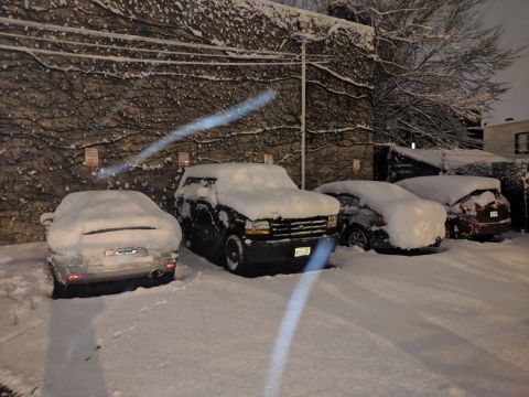 1995 Ford Bronco - Several vehicles covered in snow, including a 1995 Ford Bronco.