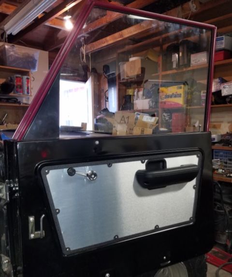 1968 Ford Bronco - Close-up of a Ford Bronco door panel, likely from a 1968 model, showing interior components.