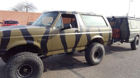 1996 Ford Bronco - This 1996 Ford Bronco features a unique camouflage paint scheme and tows a matching trailer.