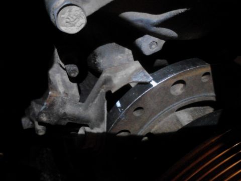1995 Ford Bronco - Detail of a vehicle's brake rotor and associated suspension components, with visible text from Supermotors.net.