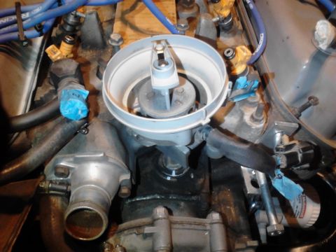 1995 Ford Bronco - Close-up view of an engine's distributor cap and rotor assembly, showing fuel injectors and hoses.