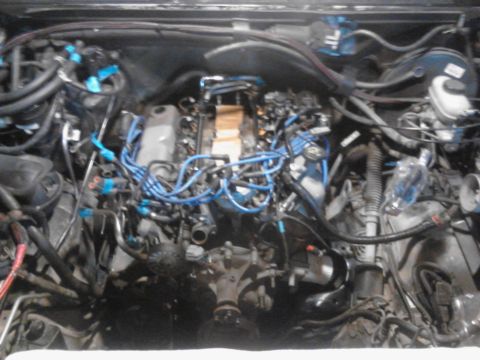 1995 Ford Bronco - Close-up view of a vehicle's engine compartment, showing complex wiring and mechanical components.