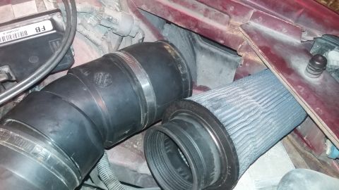 2000 Pontiac Grand Prix - Engine bay view showing an aftermarket air intake system with a conical filter.