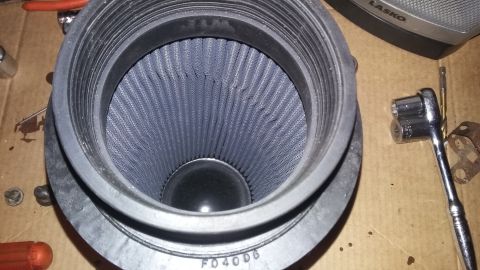 2000 Pontiac Grand Prix - Close-up of a used air filter with tools nearby, suggesting a maintenance or replacement task.