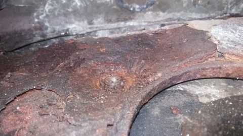 2000 Pontiac Grand Prix - A close-up view of a heavily corroded metal component, likely from a vehicle's undercarriage.