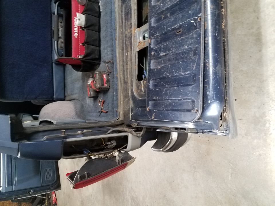 1987 Ford Bronco rear interior with tools and detached taillight