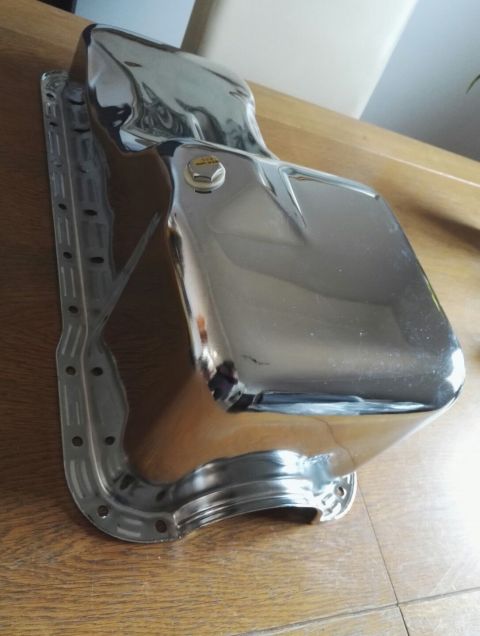 1974 Ford Ranchero - A shiny chrome oil pan is shown, likely an aftermarket part for a vehicle.