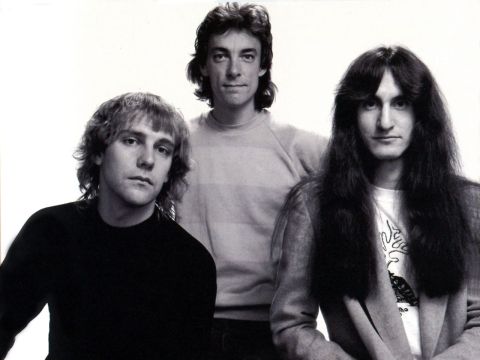 1967 Ford Custom Wagon - A black and white studio portrait of three men with long hair, likely a band, posing for a photo against a white background. The man on the…