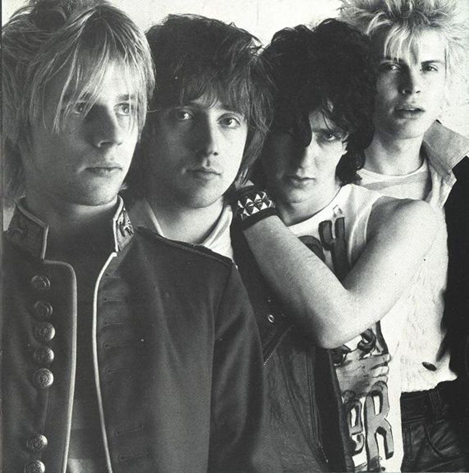 Four young men posing for a photo.