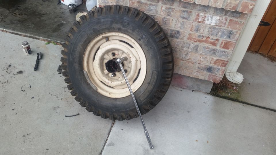 Tire and rim assembly with a socket wrench attached to a lug nut.