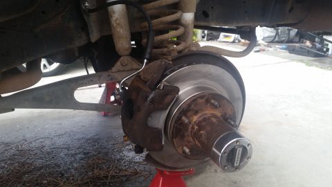 1985 Ford Bronco - Close-up of a vehicle's front brake assembly, a WARN locking hub.