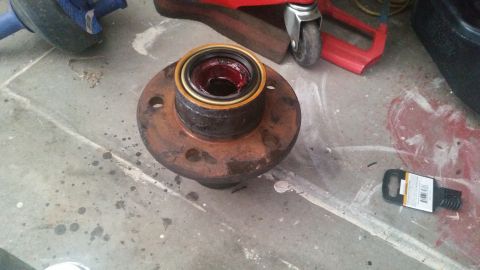 1985 Ford Bronco - Wheel hub assembly with bearing and grease, likely for a vehicle repair.