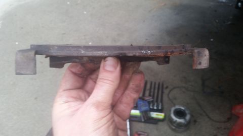 1985 Ford Bronco - Close-up of a used brake pad, likely needing replacement.