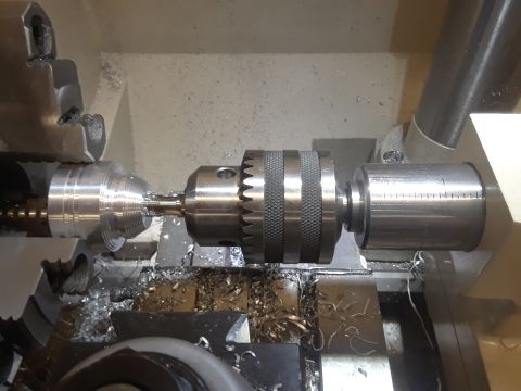 1994 Ford Bronco - Machining metal parts on a lathe, with visible metal shavings.
