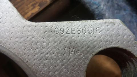1973 Ford Mustang - A metal component displays stamped identification numbers, possibly a part number or casting code.