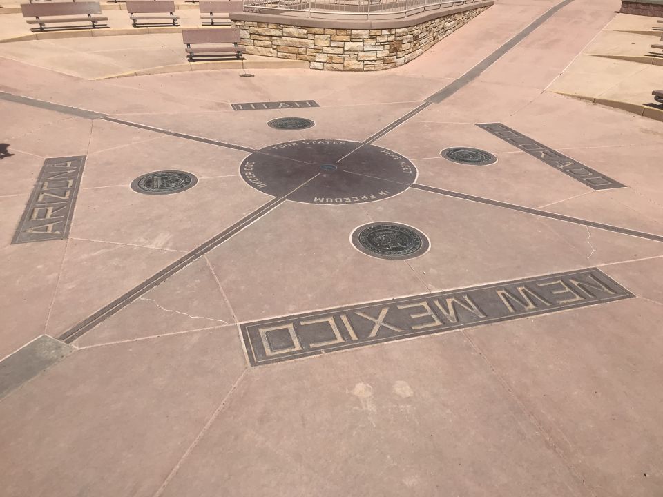 Ground markers indicate the intersection of Arizona, New Mexico, Utah, and Colorado