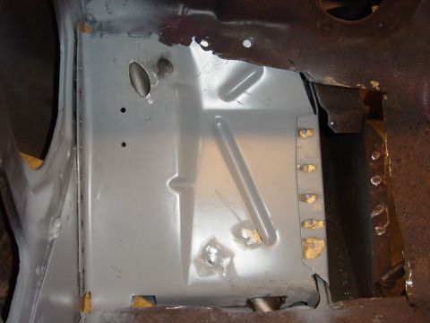 1965 Ford Mustang - This image shows the interior of a vehicle's floor pan area, likely during a restoration or repair. A section of the floor pan has been rep…