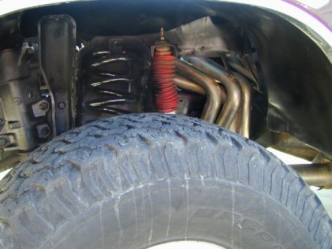 1979 Ford Bronco - Front suspension components and exhaust headers are visible in this close-up shot.