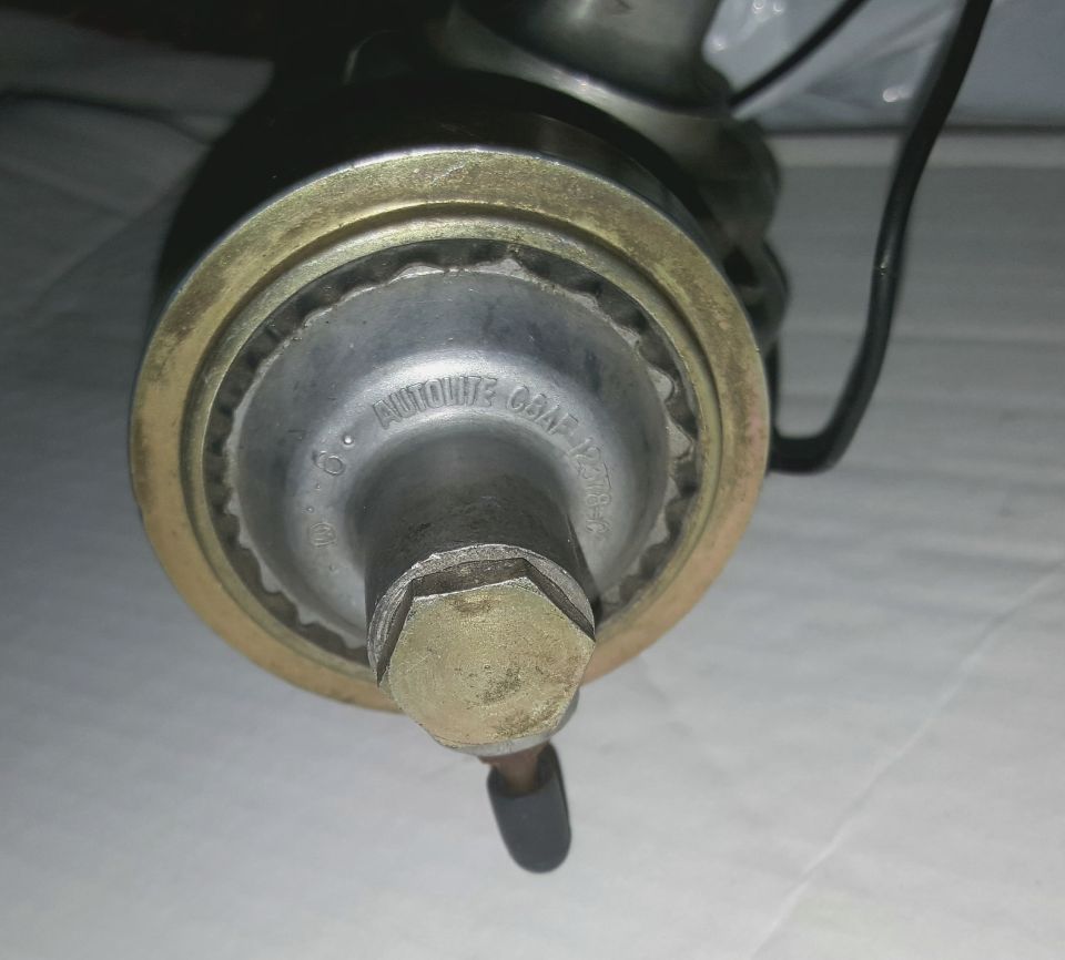 Close-up of an AUTO-LITE branded part with a hex nut.