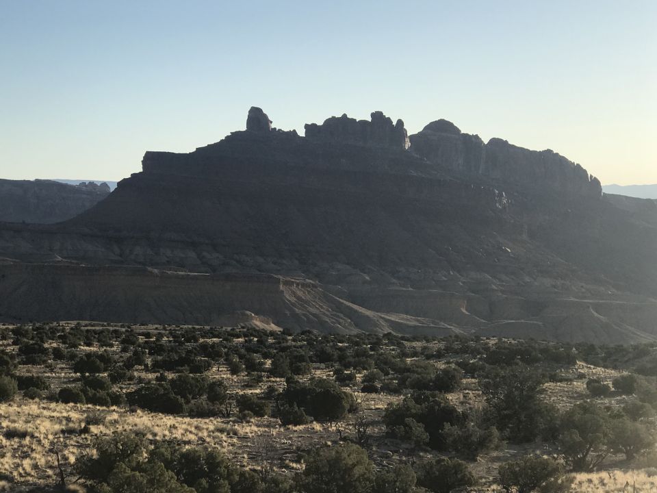 Desert landscape with a large mountain range in the background.
