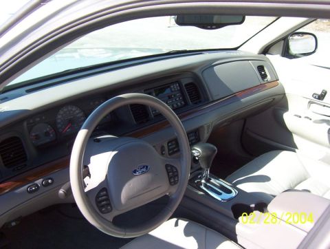 2002 Ford Crown Victoria - Dashboard and interior of a 2002 Ford Crown Victoria, showing the steering wheel and gear shifter.