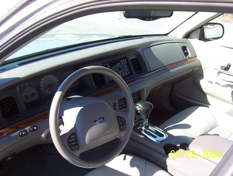Interior view of a 2002 Ford Crown Victoria showing dashboard, steering wheel, and center console