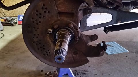 1996 Ford Bronco - Once the hub is gone, and the brake caliper is removed, take your 4-prong socket and remove the nuts holding the wheel bearings in. There i…