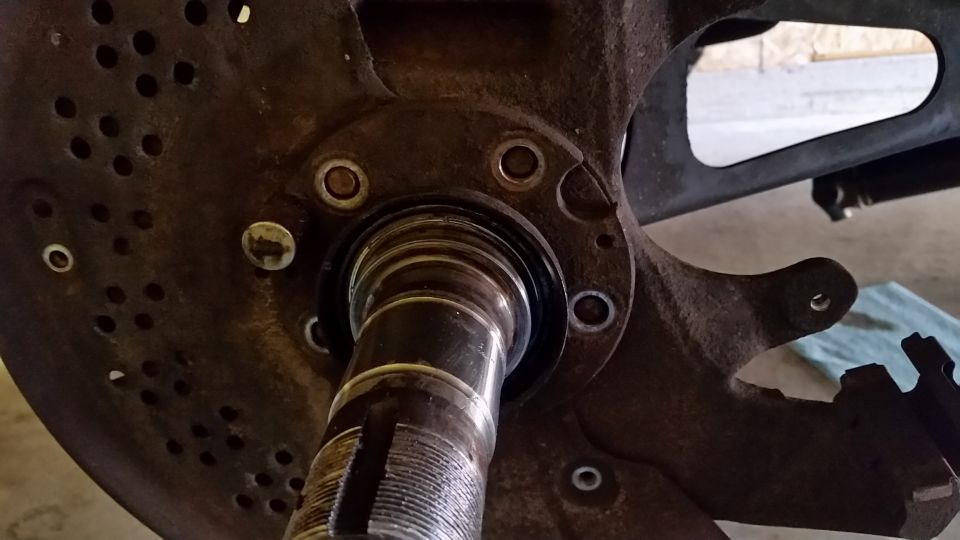 To aid in spindle removal, I like to tap the bolts that hold in in place out.  Less struggle removing the spindle.  Lucky for me I had the spindle off a few weeks ago when I did the ball joints, so it didn't take much effort to remove.