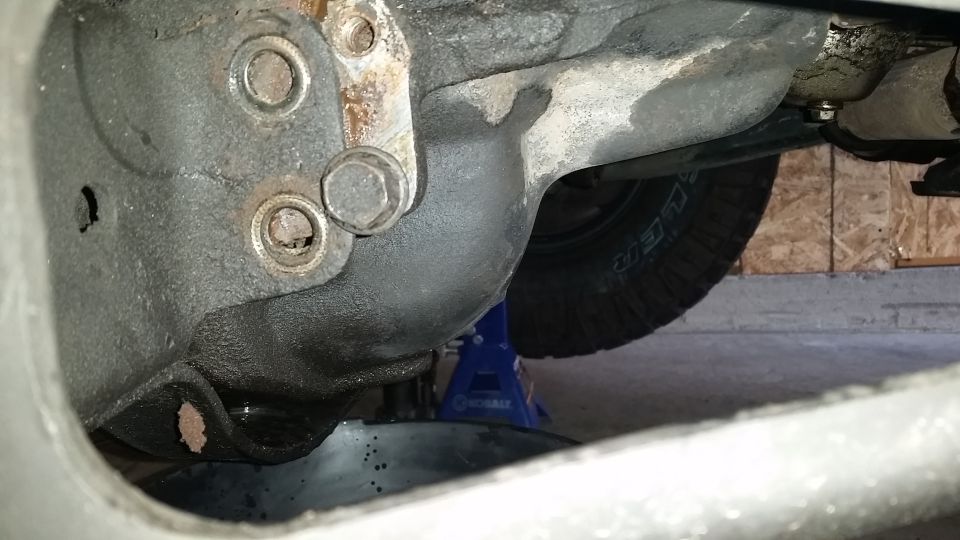 With the upper bolt still loosely holding the 3rd member, lift the 3rd member up and drain it.  I threaded one of the side bolts back to hold the 3rd member in position and gave it time to drain as much as possible.