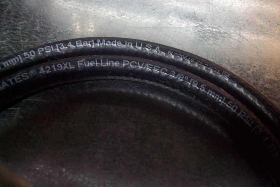 Black fuel line hose with text 'Gates 4219XL Fuel Line PCV/EEC 3/8" [9.5 mm] 50 PSI [3.4 Bar] Made in U.S.A.'