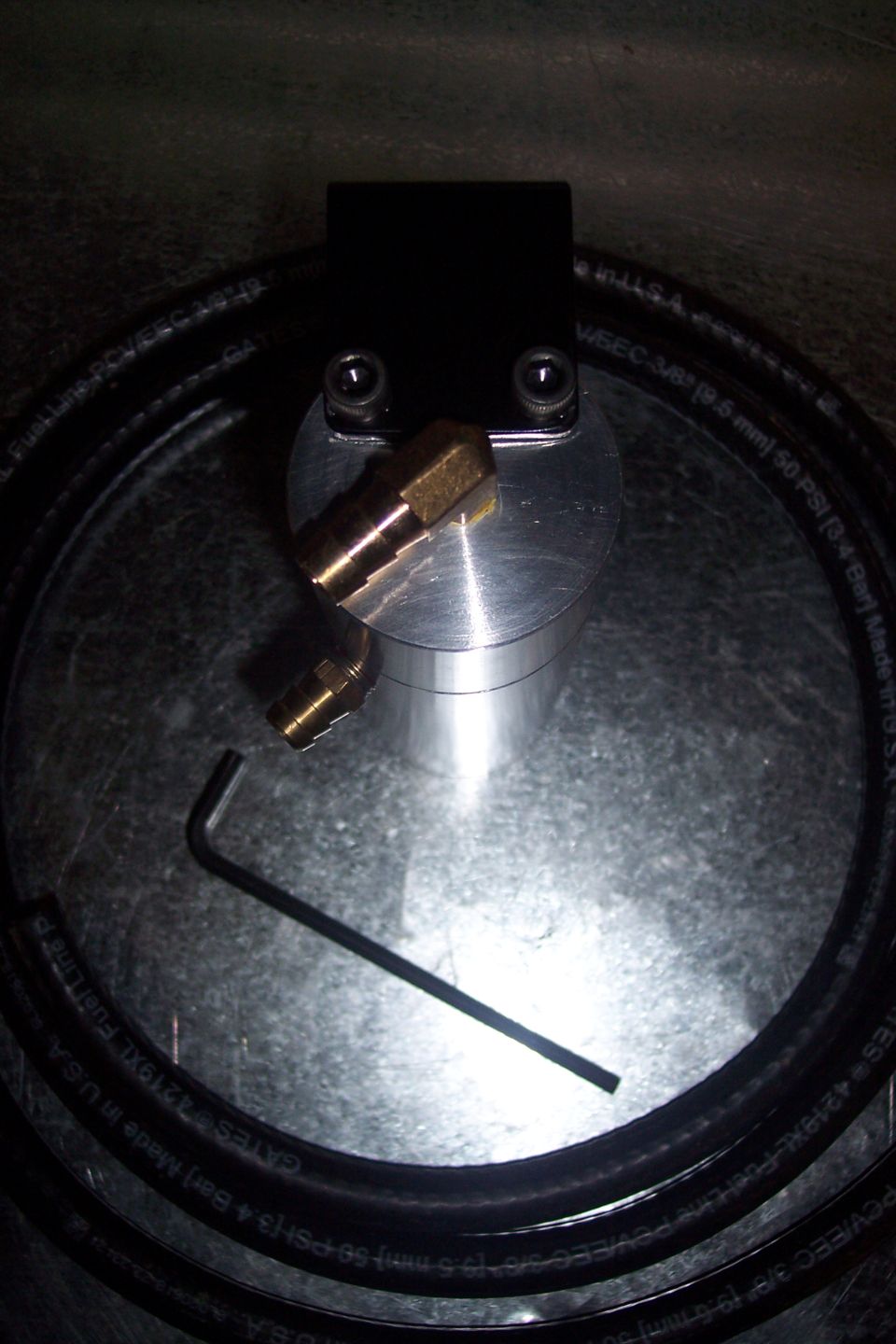 Black oil catch can with brass fittings and coiled hose