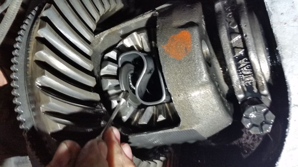 Push in on both axles to expose the C-clip further.  They can then be removed with some needle nosed pliers, or as I did, with a small magnet.