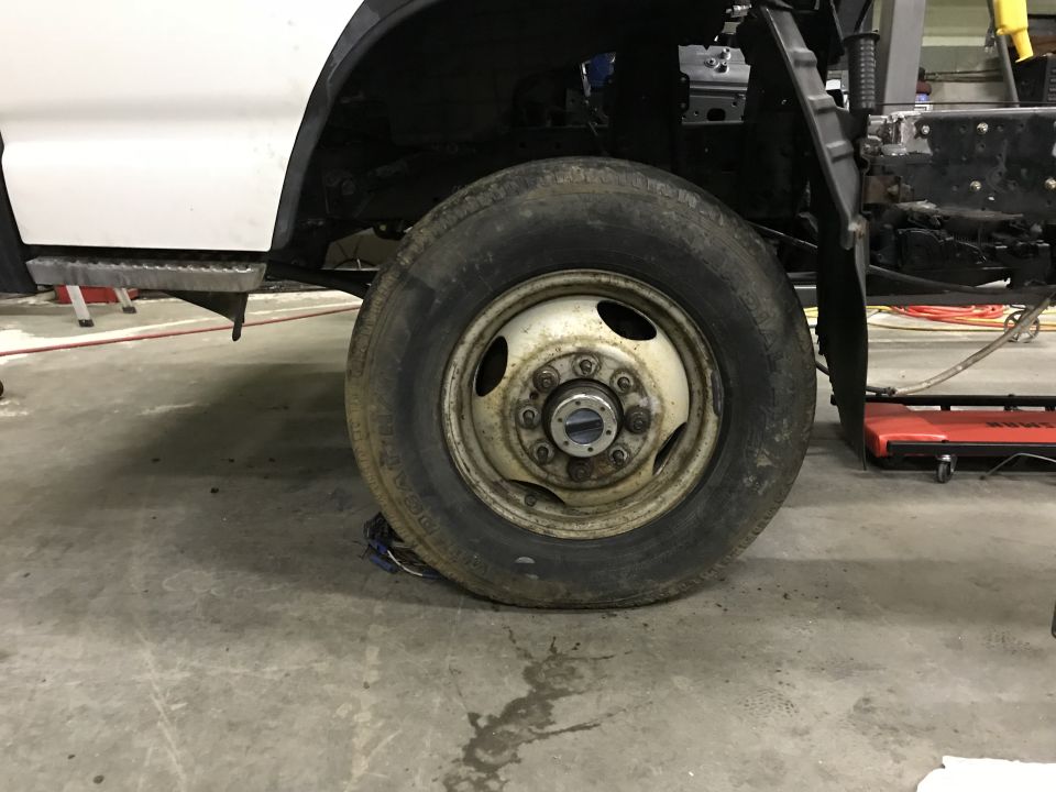 White pickup truck front passenger wheel and fender area