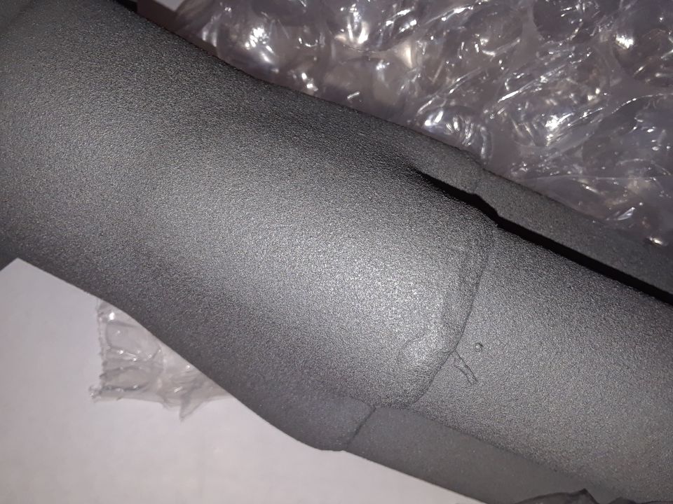 Textured dark gray exhaust pipe with bubble wrap