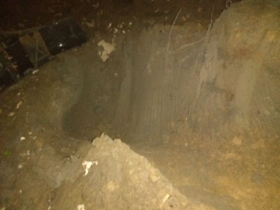 Dirt ditch with tire tracks and debris, Supermotors.net logo in lower right