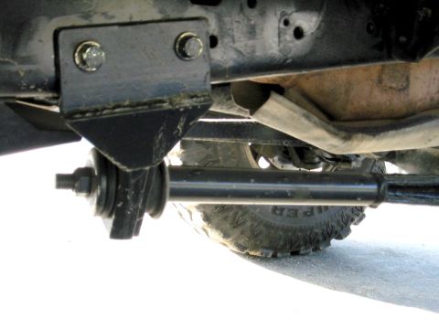 1985 Ford Bronco - Close-up view of the undercarriage of a vehicle, focusing on suspension and tire details.