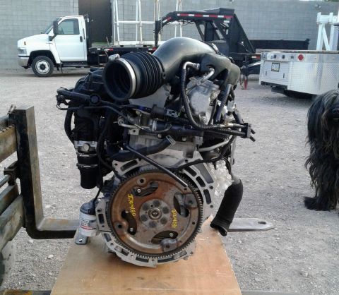 1995 Peterbilt 379 - Engine assembly displayed on a forklift, with visible text on the flywheel.